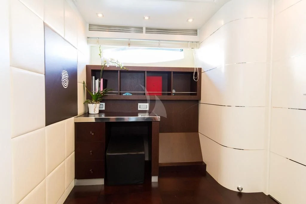 a kitchen with a black counter and cabinets aboard CINQUE Yacht for Sale