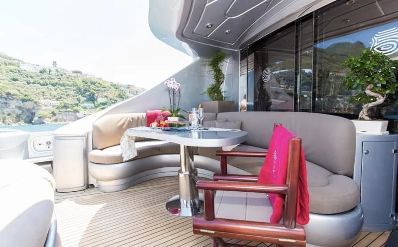a room with a table and chairs aboard CINQUE Yacht for Sale