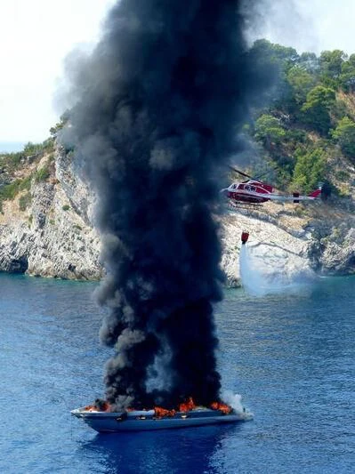 a helicopter flying over a boat aboard CINQUE Yacht for Sale