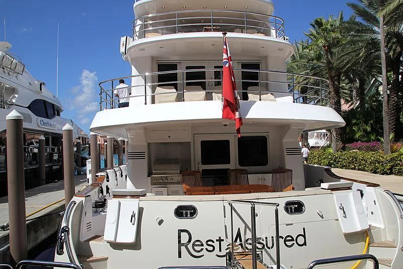a boat with a flag on the deck aboard WARBIRD Yacht for Sale