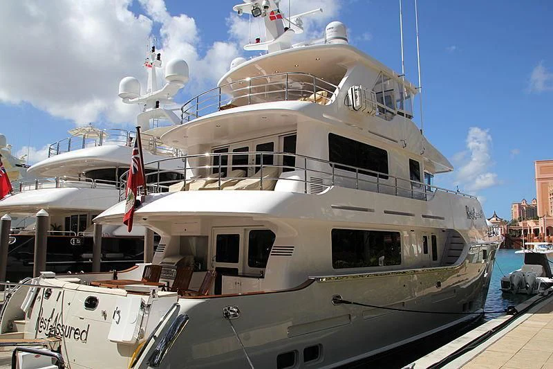 a large white boat in a harbor aboard WARBIRD Yacht for Sale