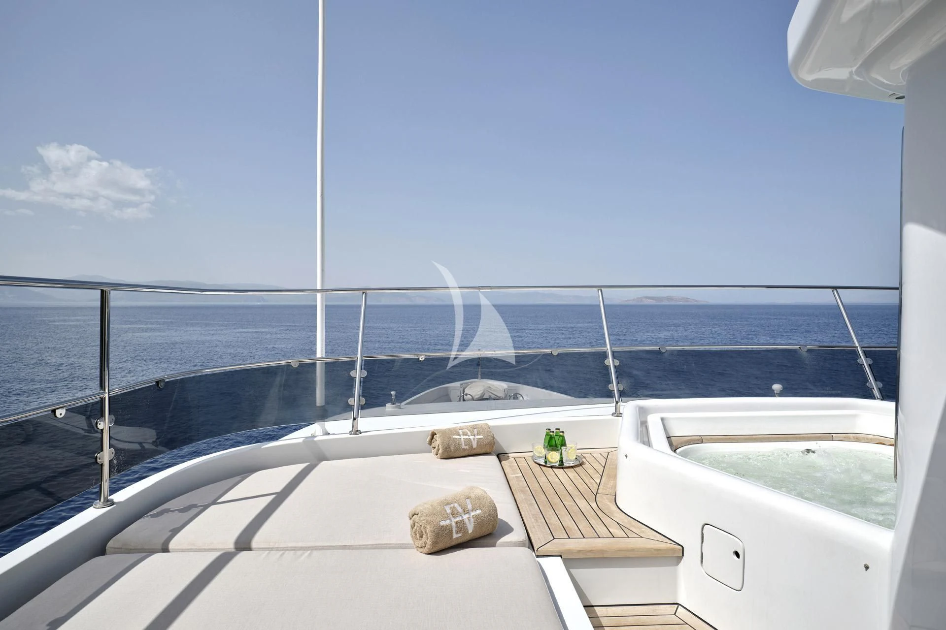 a deck with a railing and a body of water in the background aboard ELENA V Yacht for Sale