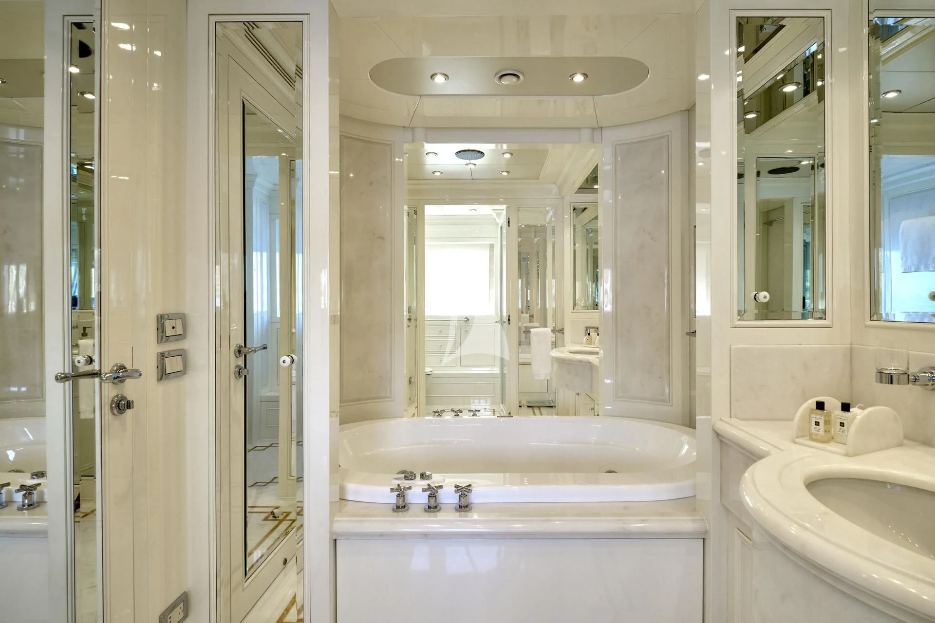 a bathroom with a tub sink and a mirror aboard ELENA V Yacht for Sale