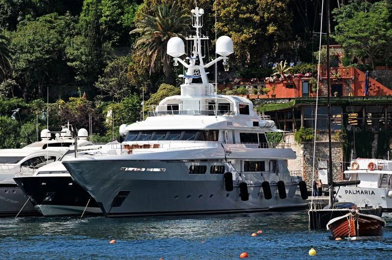 a large white boat in a harbor aboard ELENA V Yacht for Sale