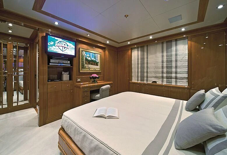 a hotel room with a bed and tv aboard ELENA V Yacht for Sale