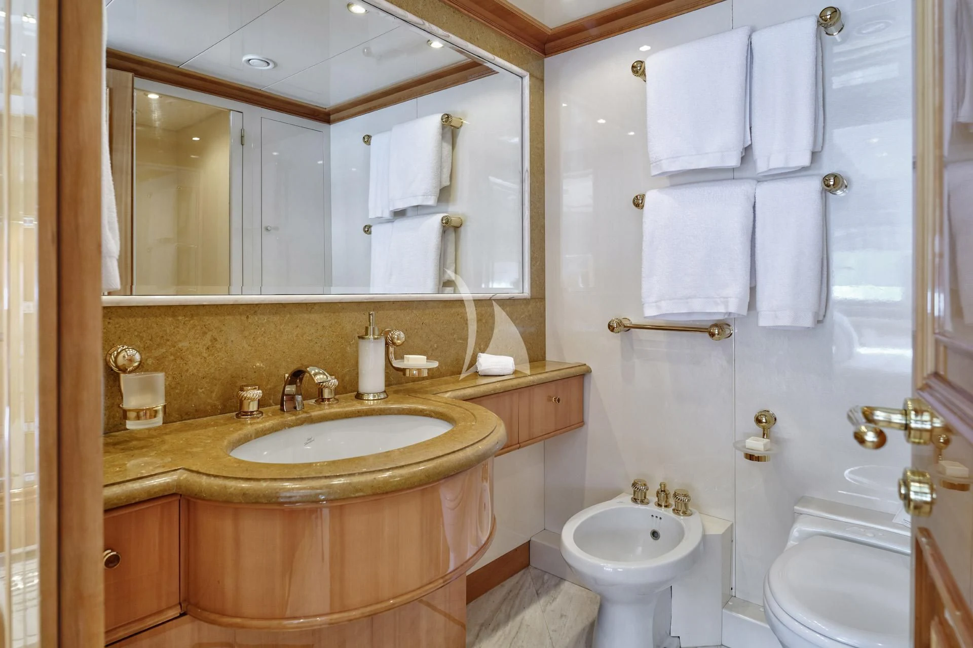 a bathroom with a sink toilet and towels aboard ELENA V Yacht for Sale