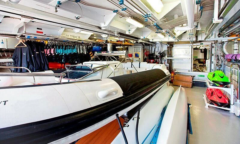 a large white car in a garage aboard ELENA V Yacht for Sale