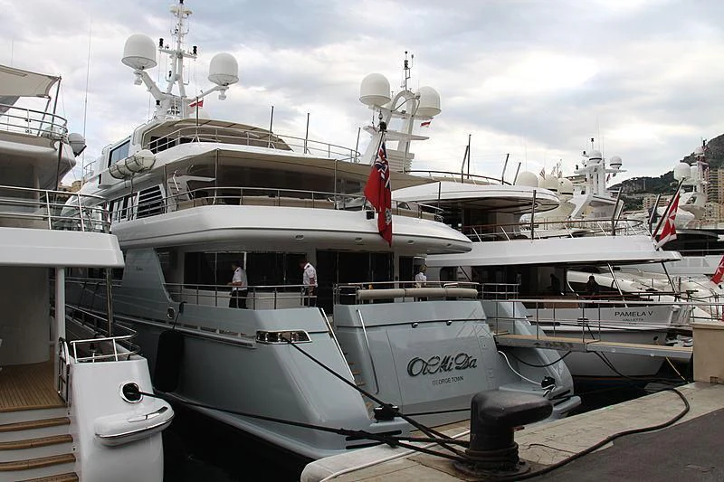 a large white boat with a red flag on it aboard ELENA V Yacht for Sale