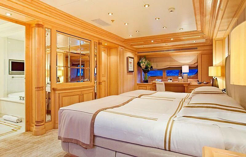a bedroom with a bed and a desk aboard ELENA V Yacht for Sale