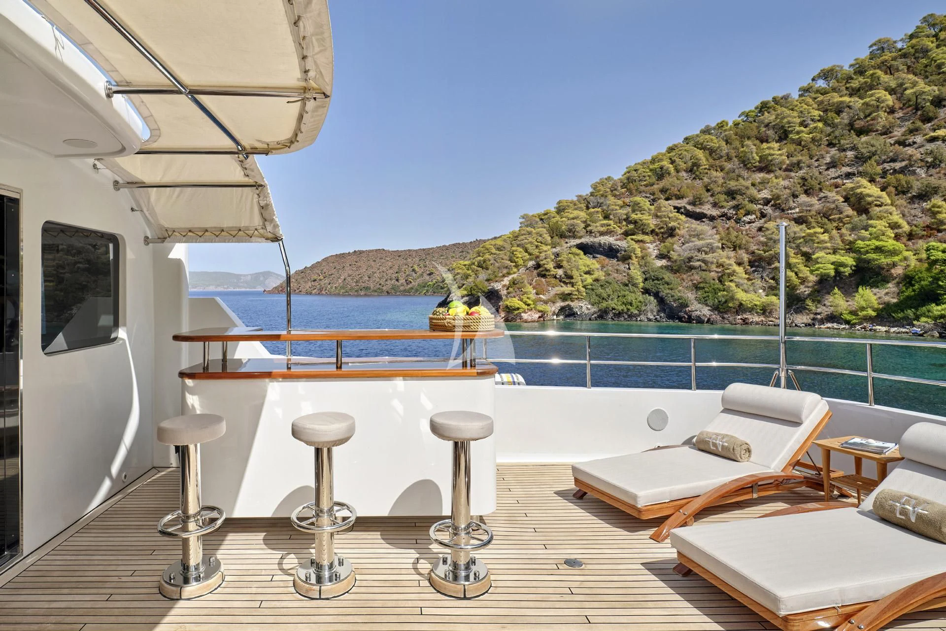a room with a pool and a deck with chairs and tables aboard ELENA V Yacht for Sale