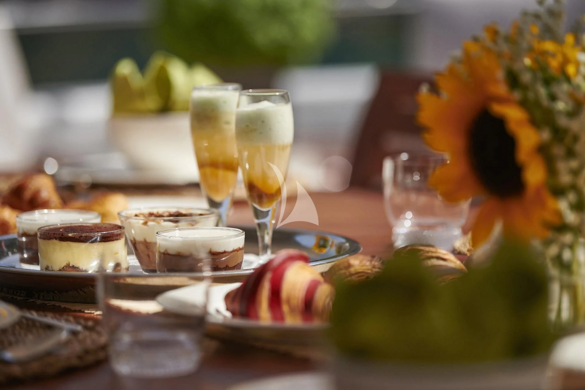 a table with food and glasses on it aboard ELENA V Yacht for Sale