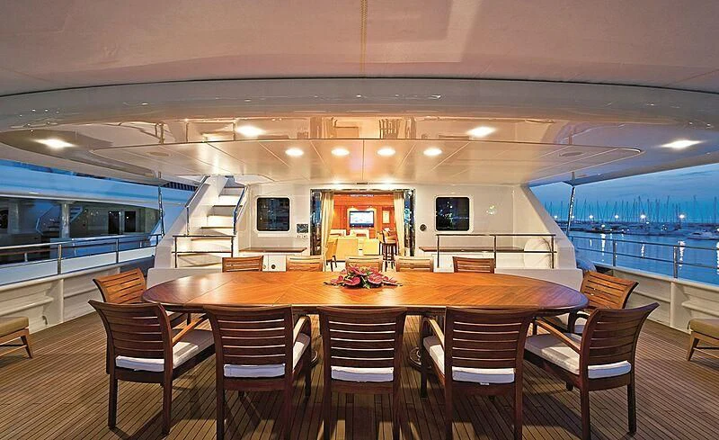 a large room with a table and chairs and a large window aboard ELENA V Yacht for Sale