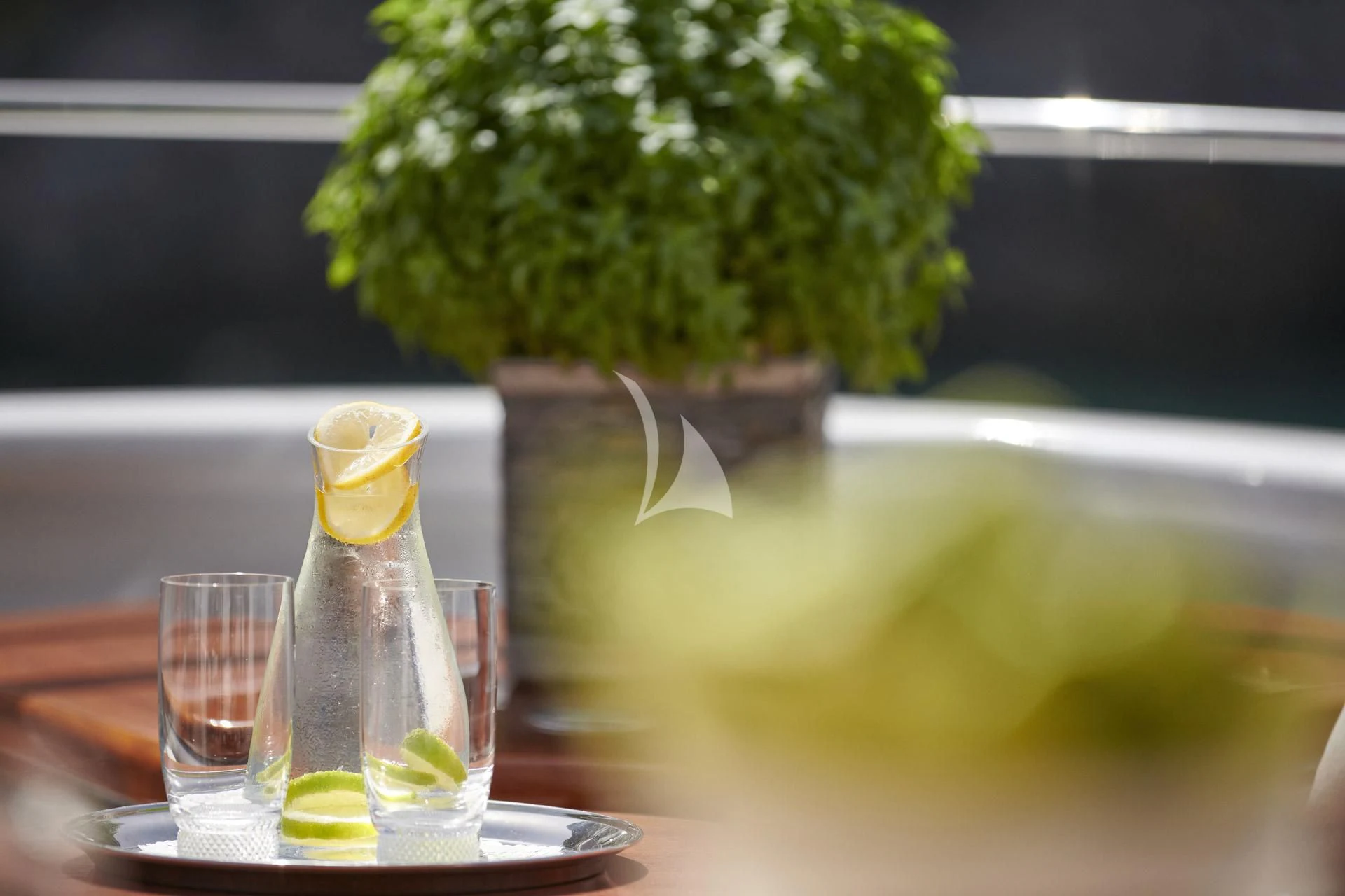 a glass bottle and a glass on a table aboard ELENA V Yacht for Sale