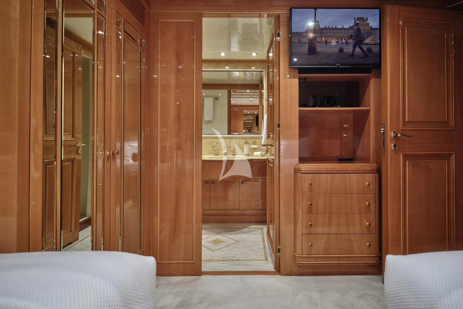 a room with a tv and a bed aboard ELENA V Yacht for Sale