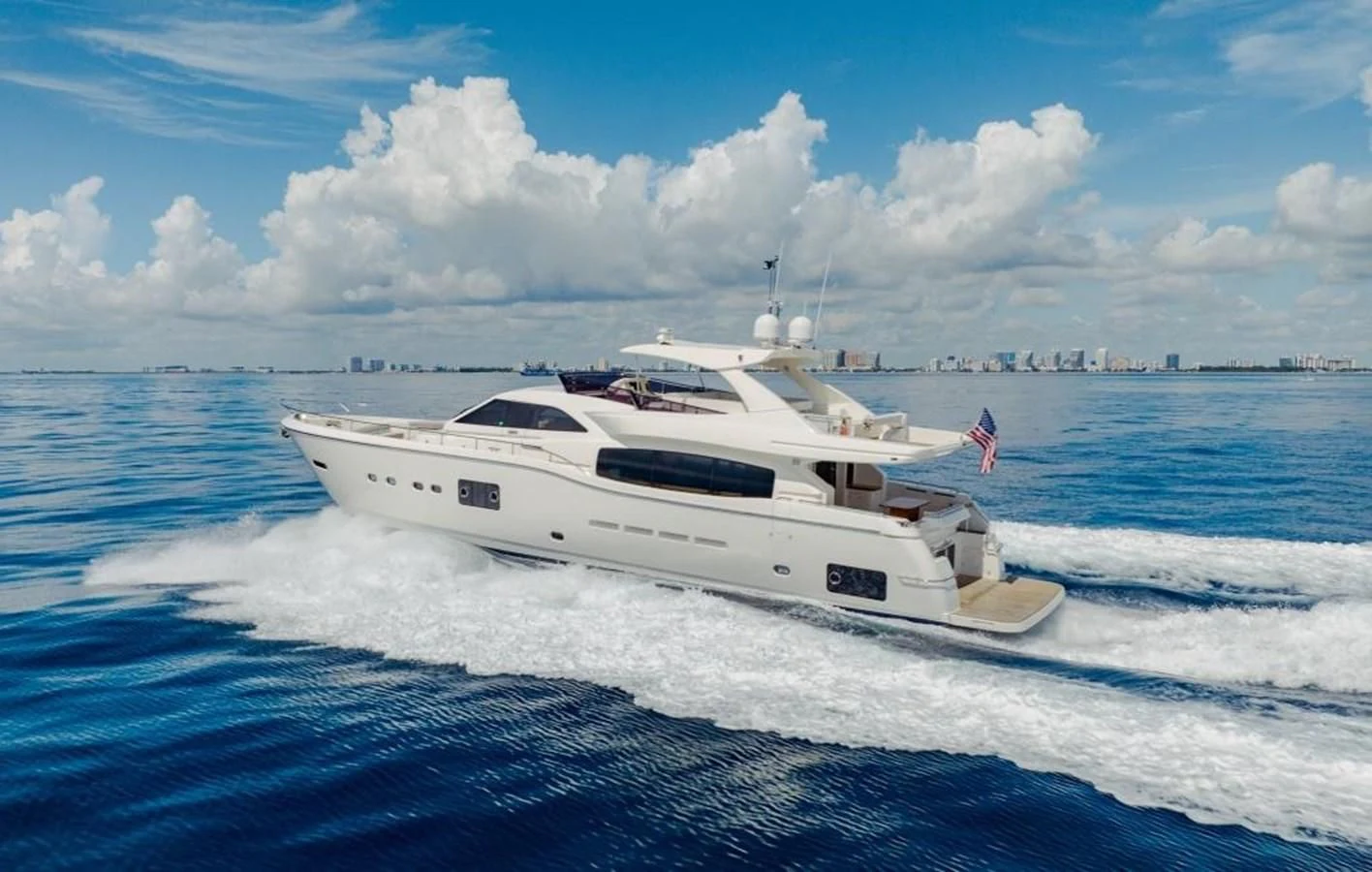 a white yacht on the water aboard SHE RUNS WET Yacht for Sale