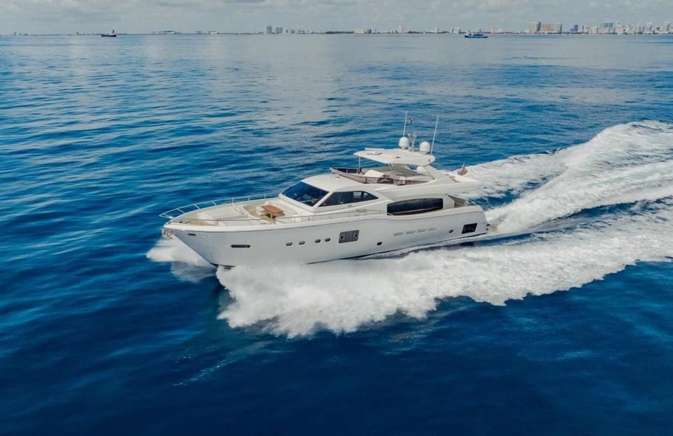a white yacht on the water aboard SHE RUNS WET Yacht for Sale