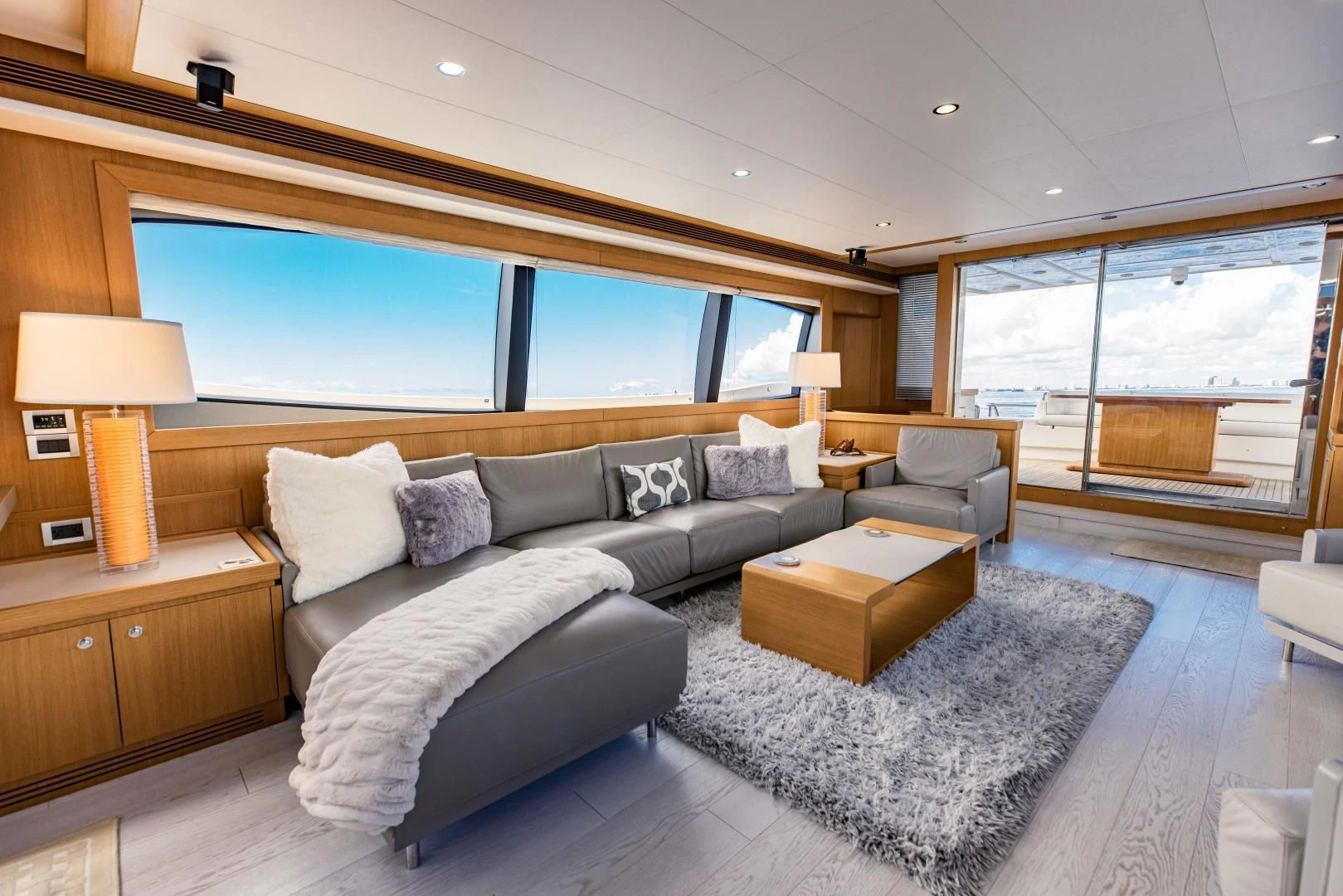 a living room with a large window aboard SHE RUNS WET Yacht for Sale