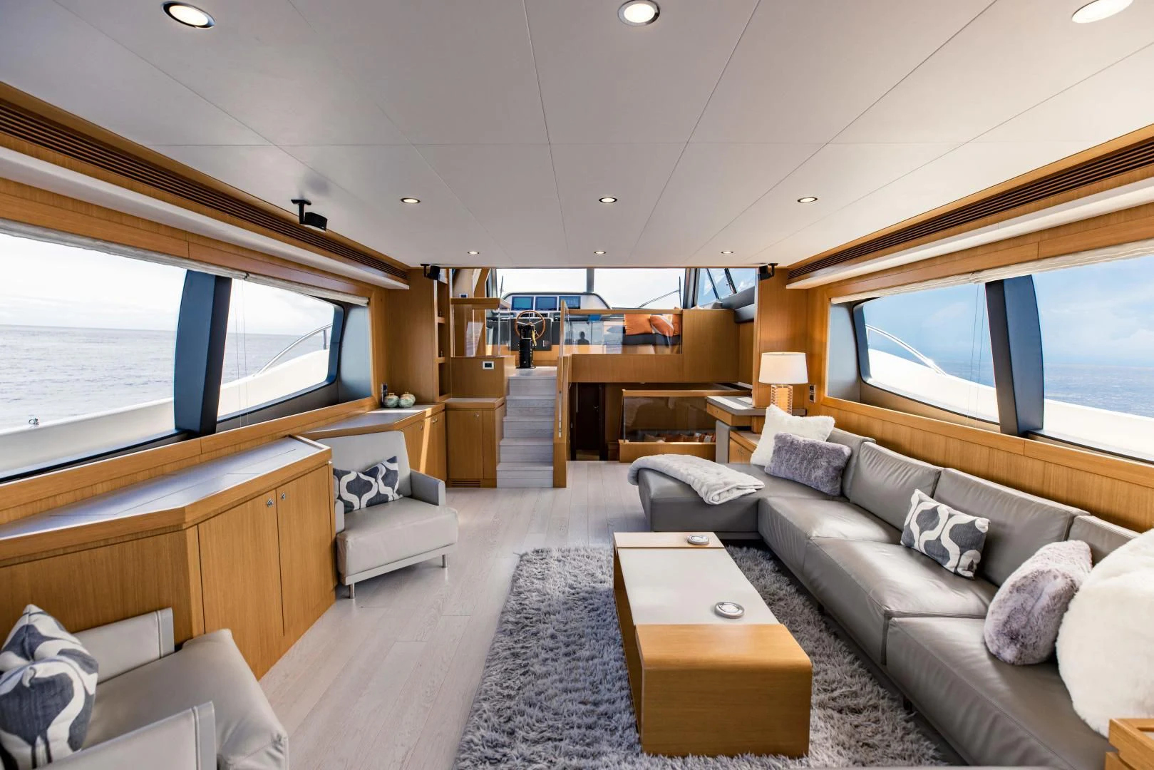a living room with a large window aboard SHE RUNS WET Yacht for Sale