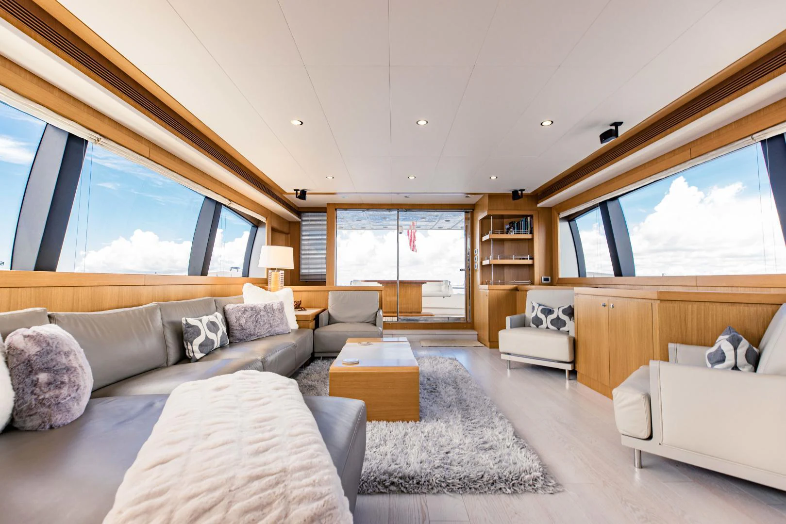 a living room with a large window aboard SHE RUNS WET Yacht for Sale