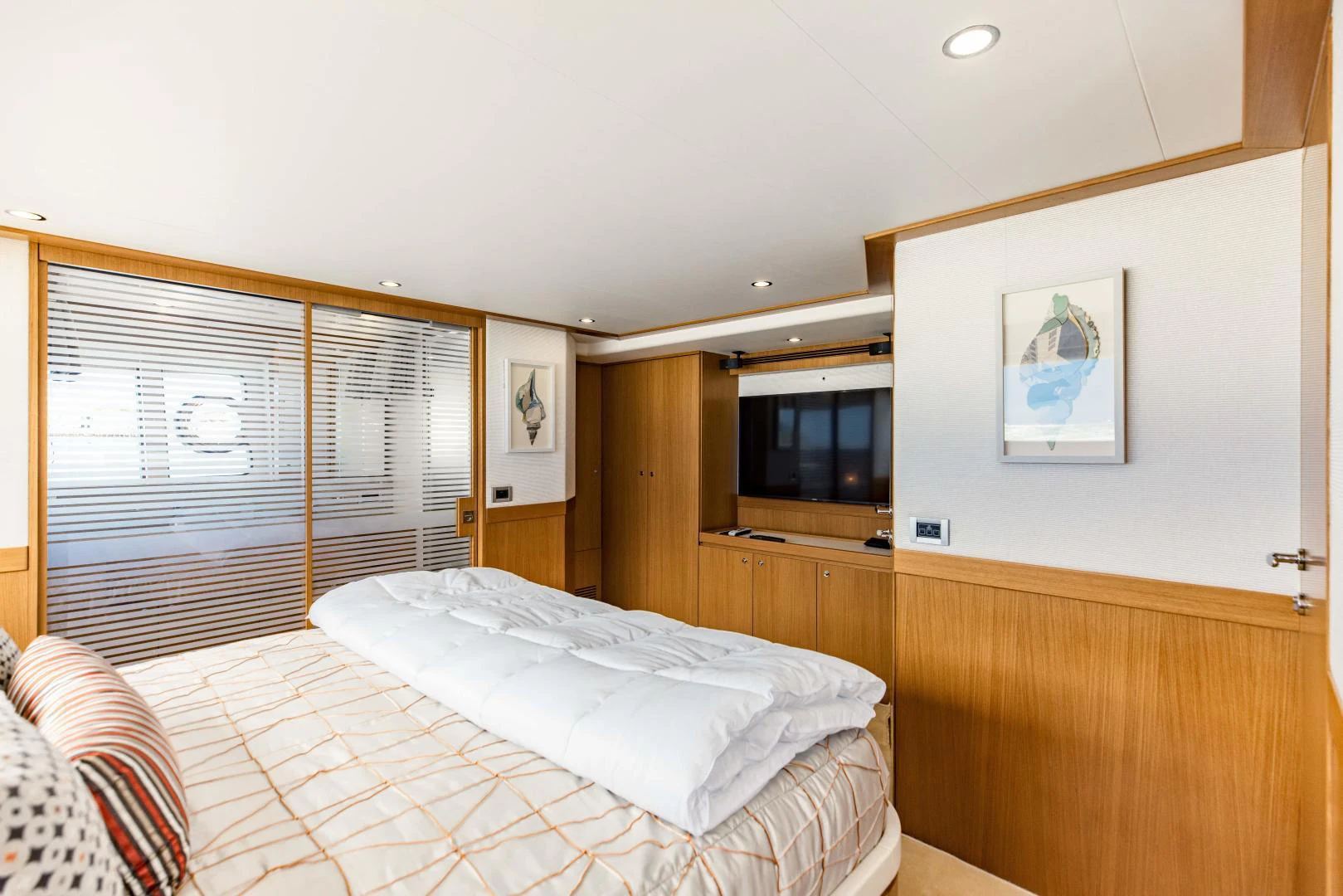 a bedroom with a bed and a television aboard SHE RUNS WET Yacht for Sale