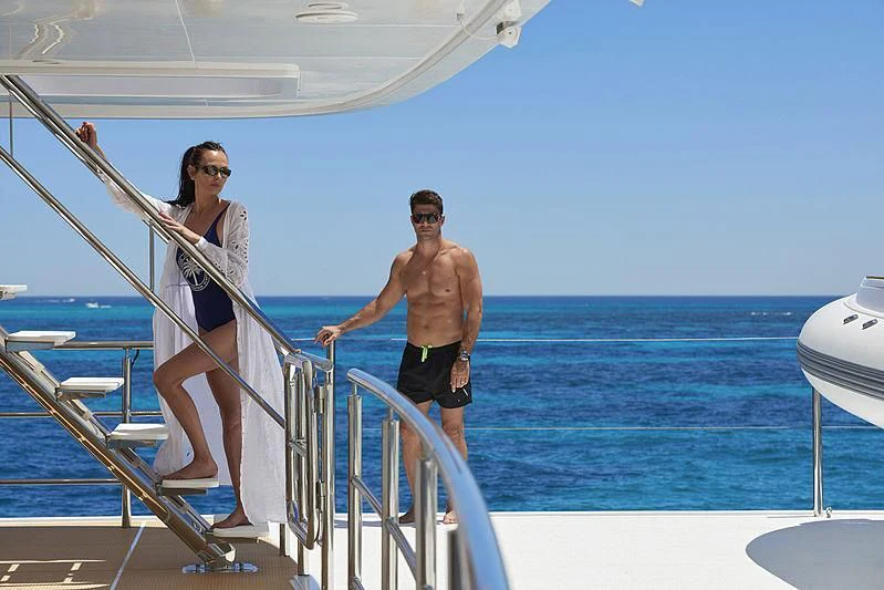a man and woman walking on a boat aboard CHARLEY Yacht for Sale