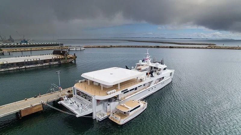 a large white ship docked at a pier aboard CHARLEY Yacht for Sale
