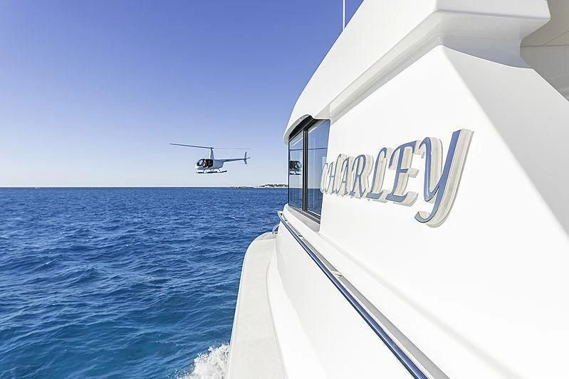 a helicopter flying over a white building aboard CHARLEY Yacht for Sale