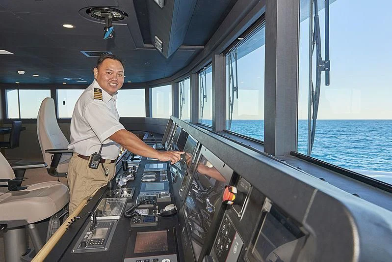 a man in a cockpit aboard CHARLEY Yacht for Sale