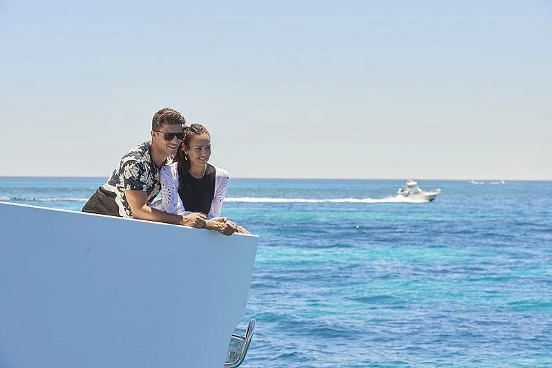 a man and woman sitting on a boat in the water aboard CHARLEY Yacht for Sale