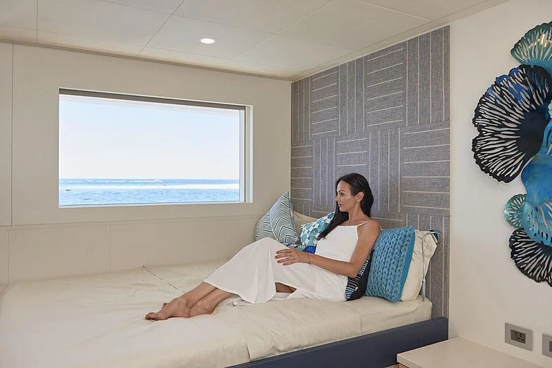 a person sitting on a bed aboard CHARLEY Yacht for Sale