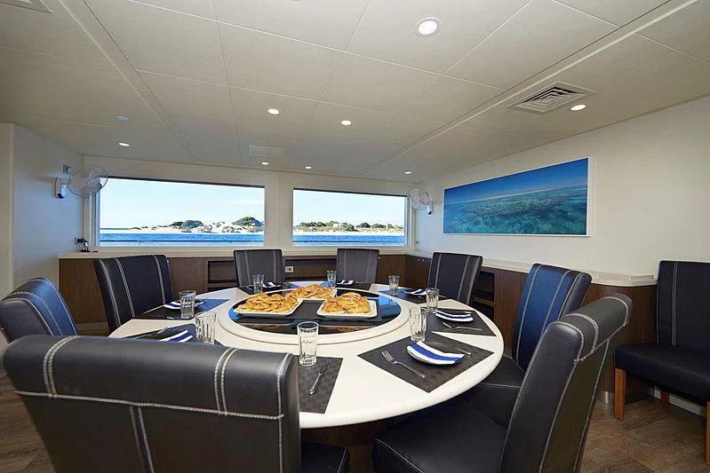 a conference room with a table and chairs aboard CHARLEY Yacht for Sale