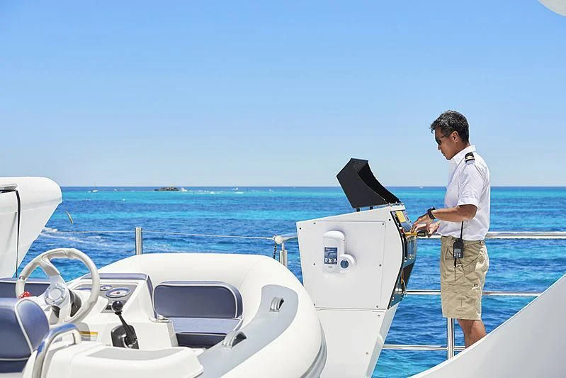 a man standing on a boat aboard CHARLEY Yacht for Sale