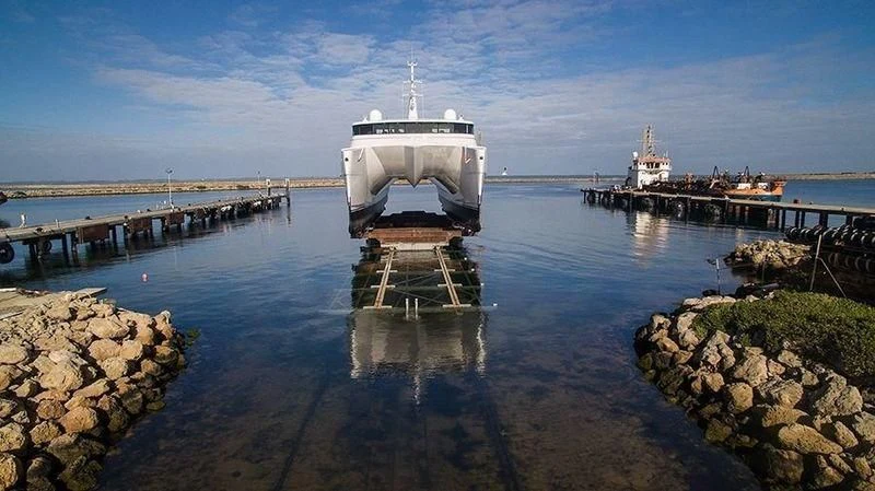 a boat in the water with Portland Breakwater Light in the background aboard CHARLEY Yacht for Sale