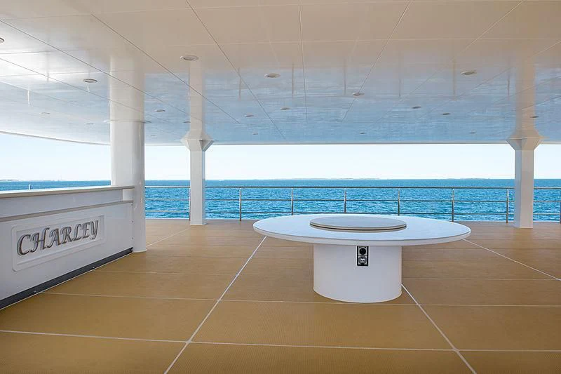 a table next to a pool aboard CHARLEY Yacht for Sale
