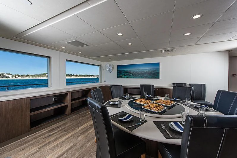 a room with a table and chairs aboard CHARLEY Yacht for Sale