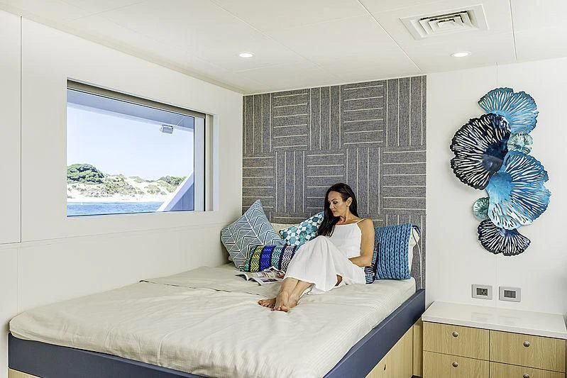 a person sitting on a bed aboard CHARLEY Yacht for Sale