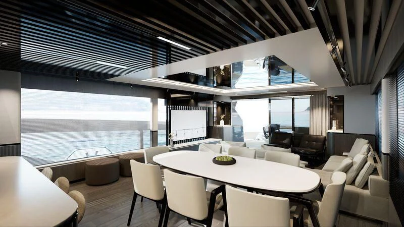 a room with a large window and a table with chairs and a large body of water aboard PEARLY SPENCER Yacht for Sale