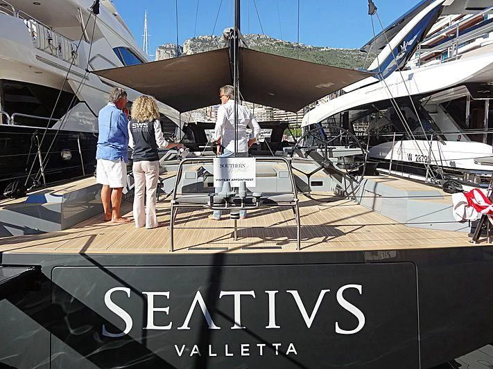 people standing next to a boat aboard SEATIUS Yacht for Sale