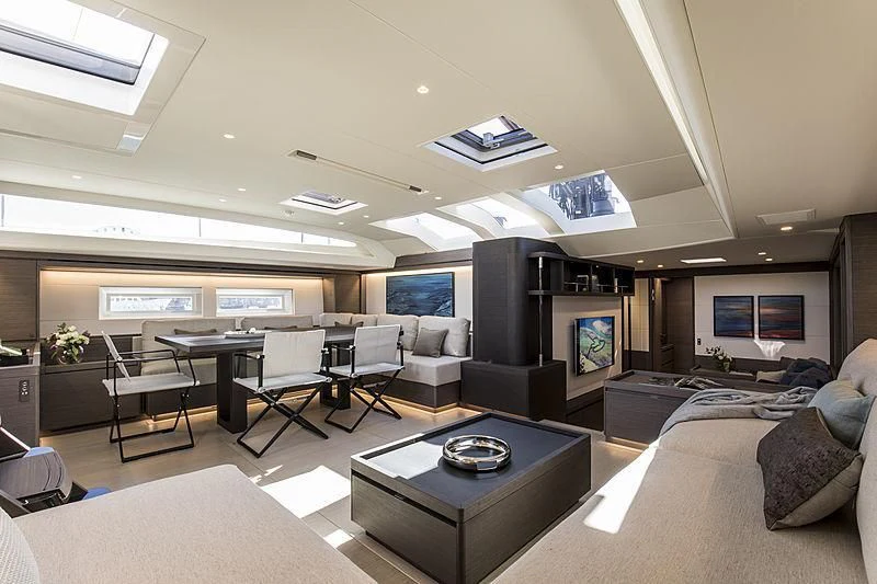 a room with a table chairs and a tv aboard SEATIUS Yacht for Sale