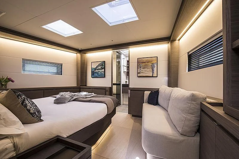 a bedroom with a bed and a couch aboard SEATIUS Yacht for Sale