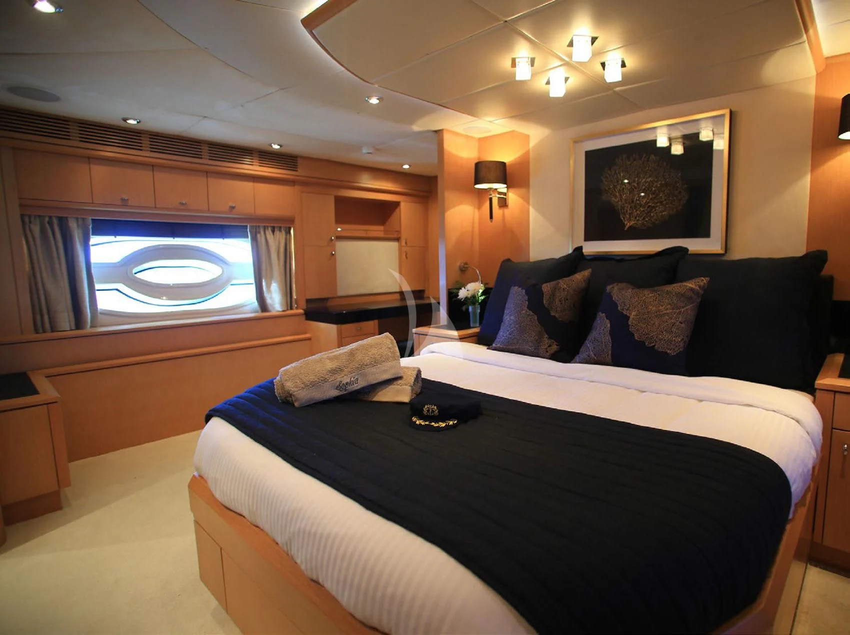 a bed with a television on the wall aboard SOPHIA Yacht for Sale