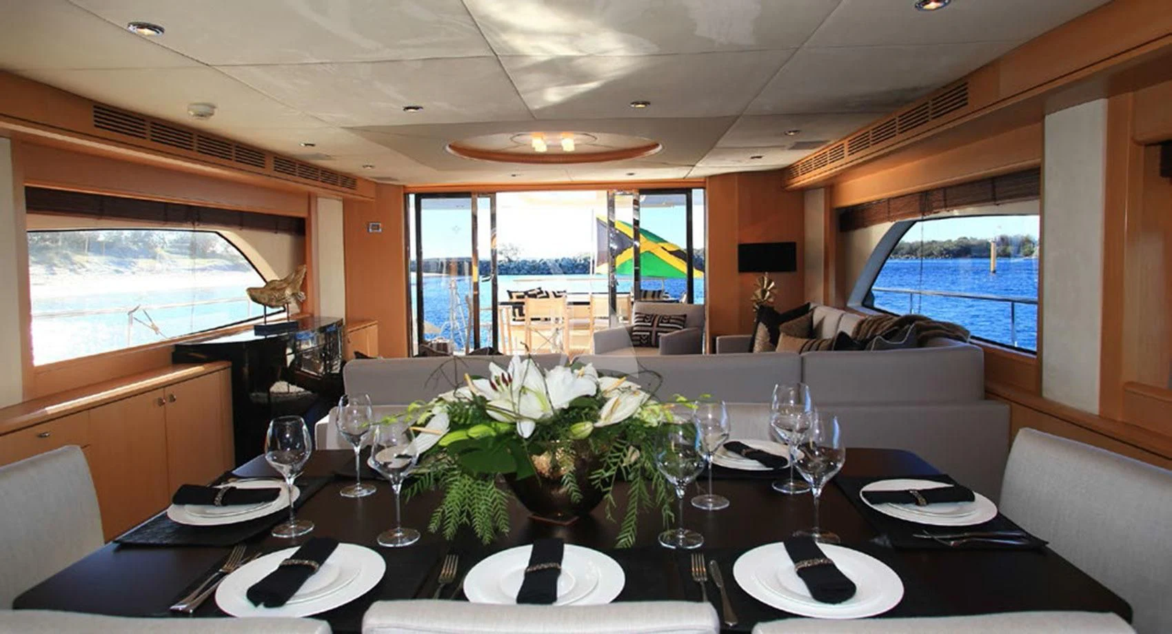 a dining table with a large window aboard SOPHIA Yacht for Sale