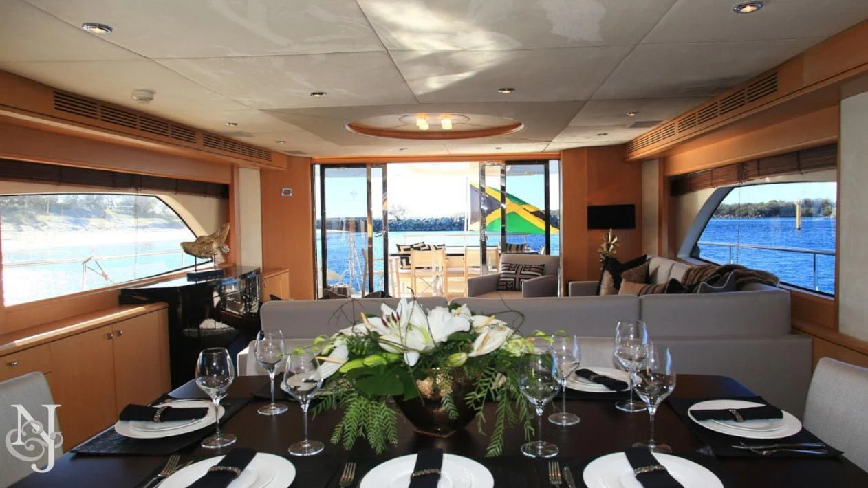 a dining room with a large window aboard SOPHIA Yacht for Sale