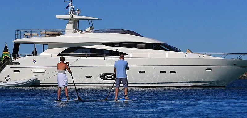 a couple of people standing next to a white boat aboard SOPHIA Yacht for Sale