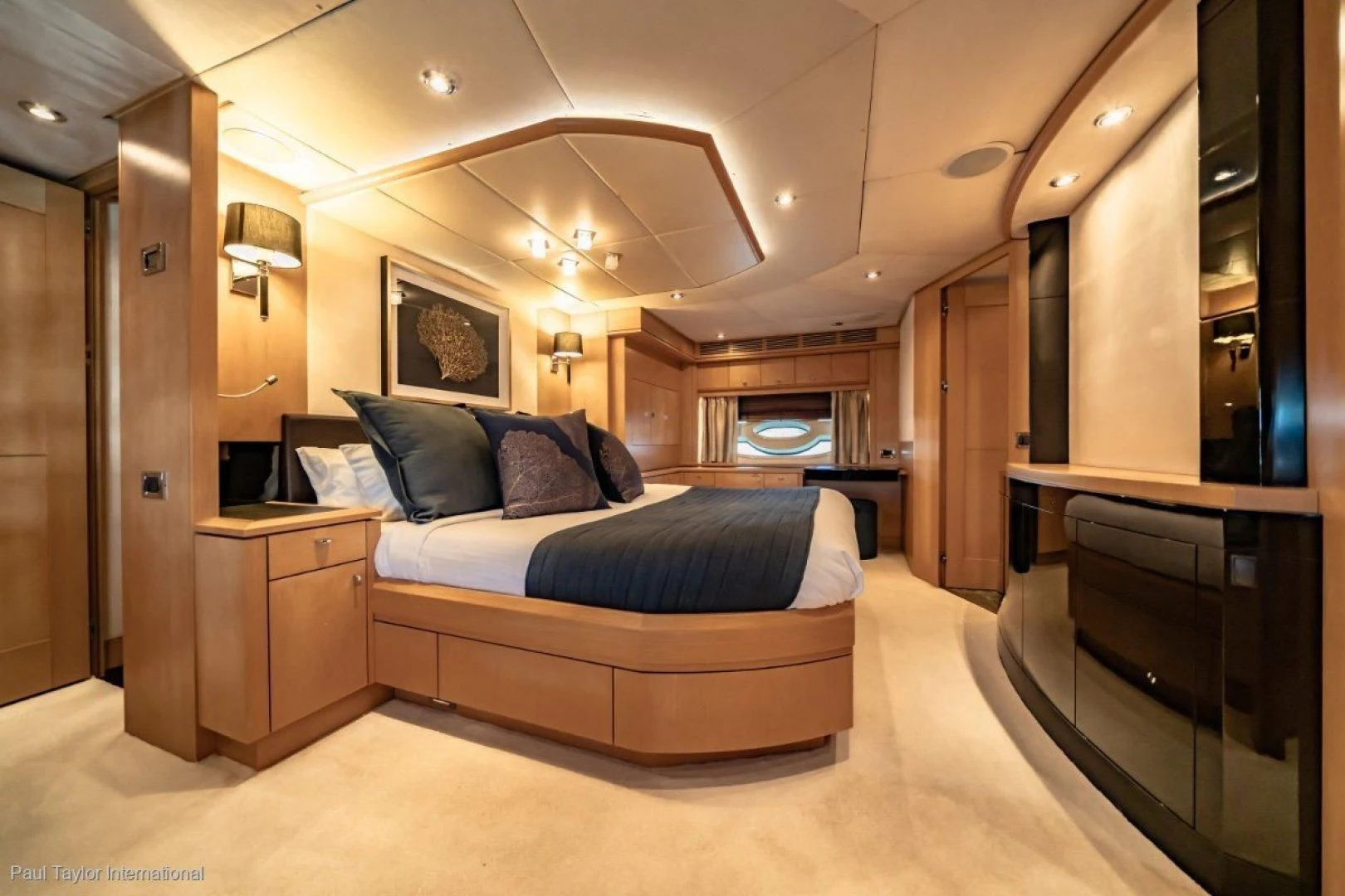 a bedroom with a bed and a desk aboard SOPHIA Yacht for Sale