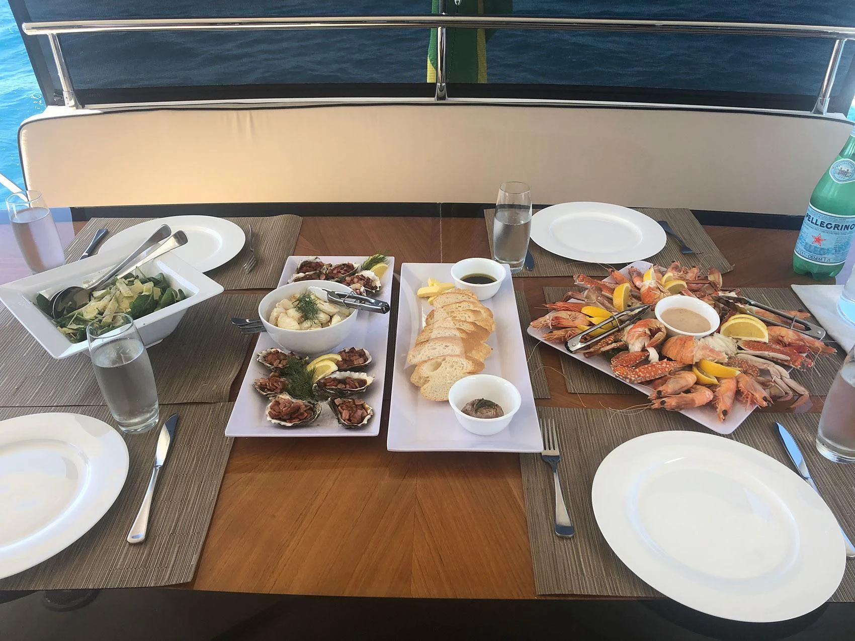 a table with plates of food and silverware aboard SOPHIA Yacht for Sale