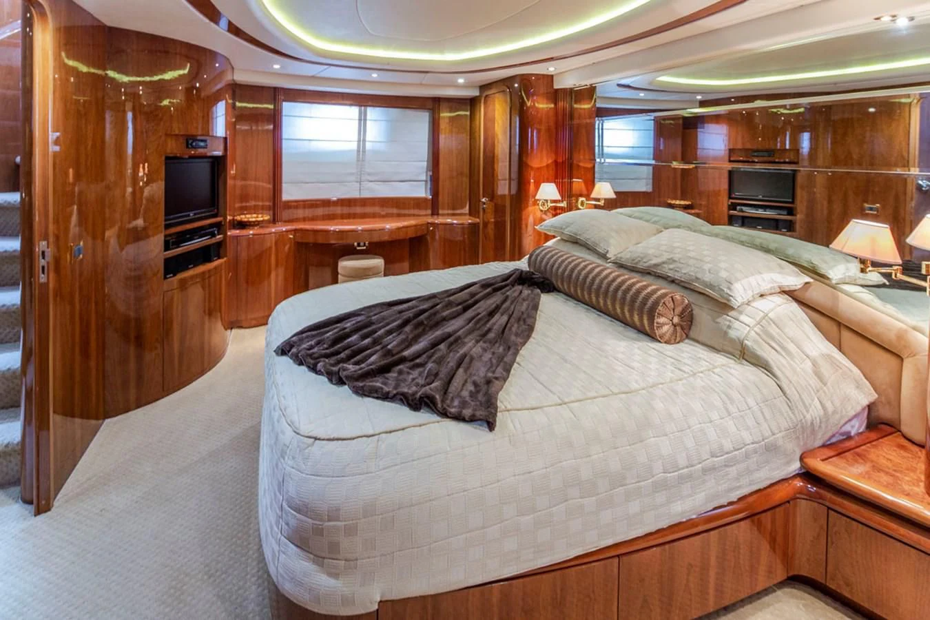 a bedroom with a bed and a wood cabinet aboard SEA HAWK Yacht for Sale