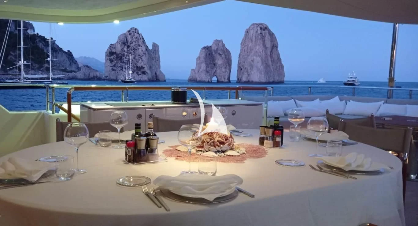 a table with food and glasses aboard ASLEC 4 Yacht for Sale