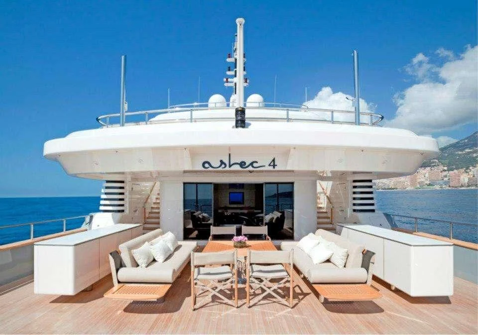 a white building with a large white boat on the water aboard ASLEC 4 Yacht for Sale