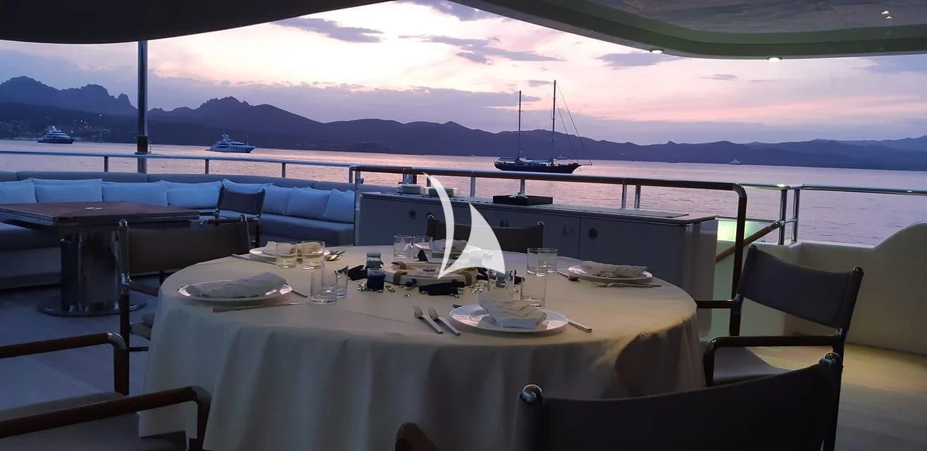 a table with chairs and a view of the ocean aboard ASLEC 4 Yacht for Sale